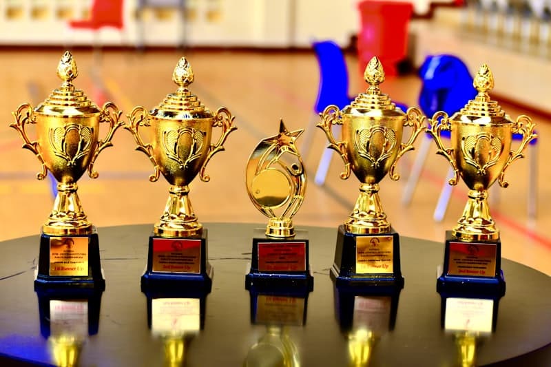 Row of golden trophies on a table